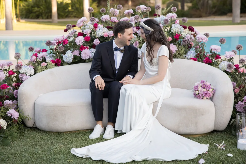 Outdoor ceremony seating framed by flowers