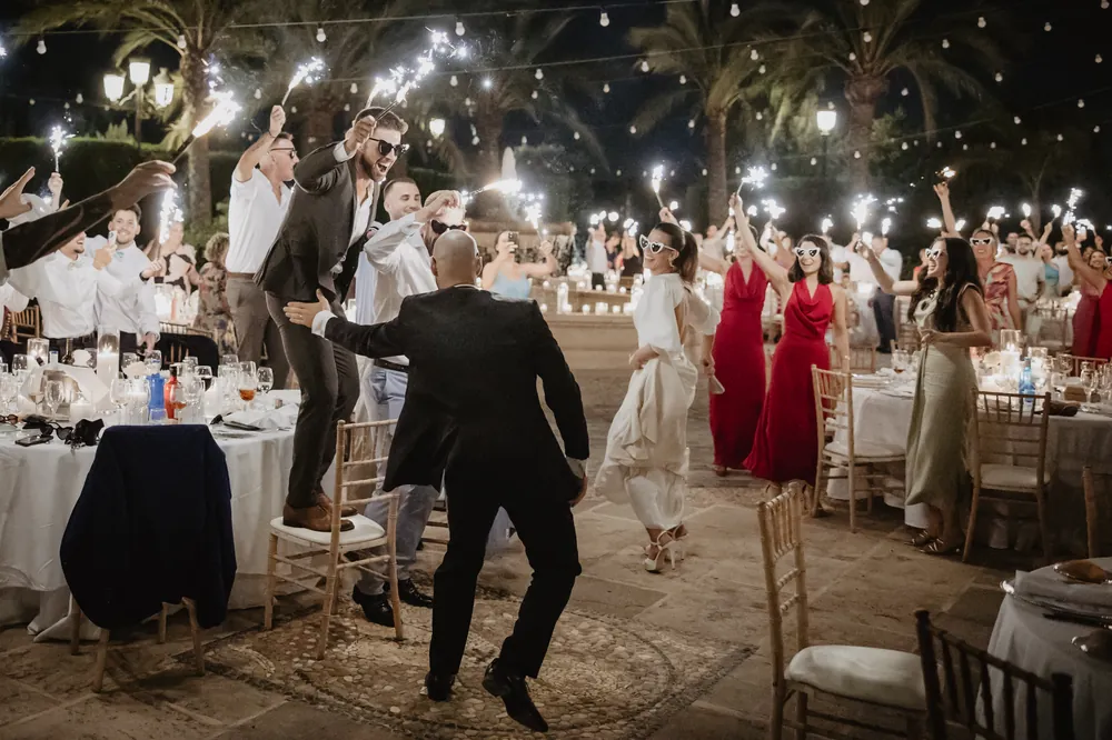 Guests standing between the dinner tables